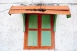 An old wooden window with zinc shade An old wooden window with zinc shade