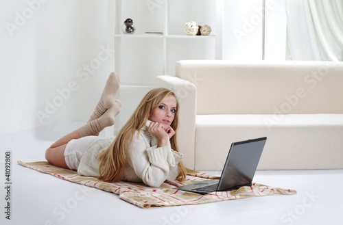 Photo: beauty girl with laptop in room beauty girl with laptop in room