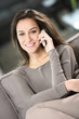 young attractive woman talking on the telephone at home