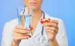 Pills, tablets and drugs heap in doctor hand, closeup view