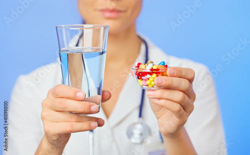 Photo: Pills, tablets and drugs heap in doctor hand, closeup view Pills, tablets and drugs heap in doctor hand, closeup view