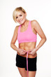 Pretty woman checking her waistline