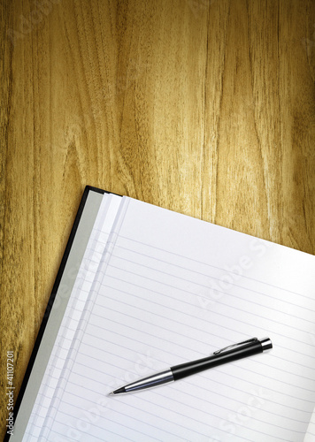 Foto: pen and notepad on desk pen and notepad on desk