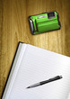 notepad and camera on desk