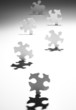 Puzzle pieces casting shadows