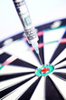 Syringes with 100 dollars inside, stuck in a dartboard