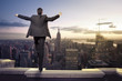 Photo: businessman standing with open arms on top of NY city businessman standing with open arms on top of NY city
