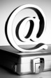 At symbol paperweight on a briefcase