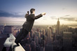 Photo: businessman standing with open arms on top of NY city businessman standing with open arms on top of NY city