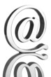 At symbol paperweight on reflective surface