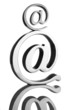 At symbol paperweight on a reflective surface