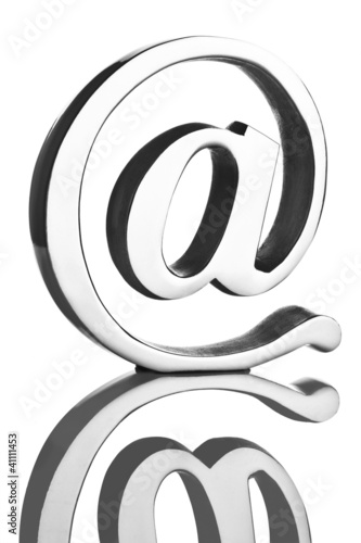 Illustration: At symbol paperweight on reflective surface At symbol paperweight on reflective surface
