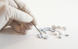 Gloved hand and medicinal pills