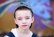 Young boy against graffiti wall