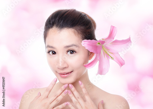 Photo: woman smile face with pink lily flower woman smile face with pink lily flower