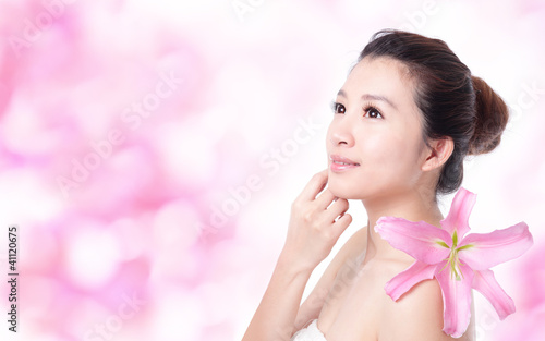 Photo: woman smile face with pink lily flower woman smile face with pink lily flower
