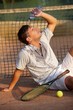 Male tennis player refreshing himself Male tennis player refreshing himself