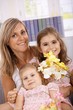 Photo: Mother and daughters smiling happily Mother and daughters smiling happily