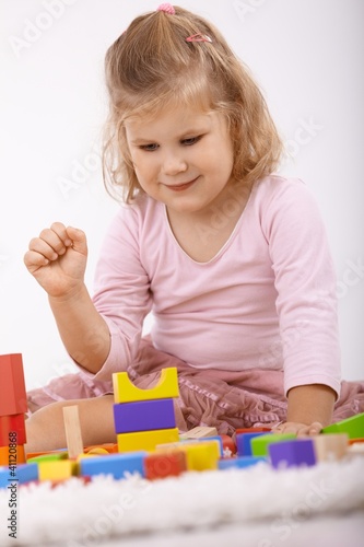 Photo: Cute little girl playing on floor smiling Cute little girl playing on floor smiling