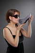 junge Frau mit Sonnenbrille küsst Schuh