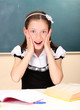 beautiful little schoolgirl in classroom
