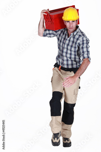 Photo: Worker running with a toolbox Worker running with a toolbox