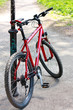 Red Bike standing near the pillar on the bike trail