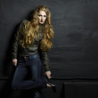 Portrait of a young red headed woman in a leather jacket