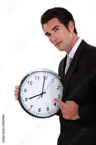 Фото: Man pointing to clock Man pointing to clock