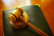 Legal gavel and leather binder on a desk