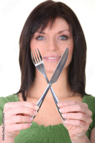 Photo: Woman showing knife and fork Woman showing knife and fork