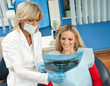 Foto: dentist and patient in dental office dentist and patient in dental office