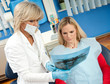 Foto: dentist and patient in dental office dentist and patient in dental office
