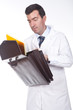 man  holding a briefcase and tooking some documents from inside