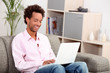 Man on couch with computer Man on couch with computer
