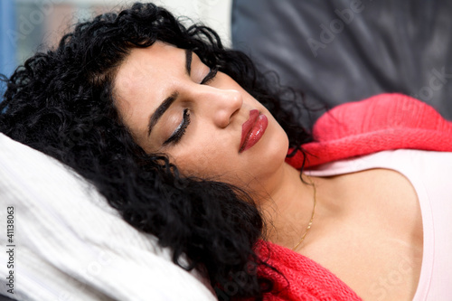 Photo: Stressed sleeping woman lying with eyes closed Stressed sleeping woman lying with eyes closed