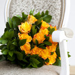 yellow roses lying on a chair