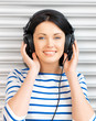happy teenage girl in big headphones