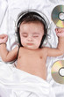 2 Month old baby listening to music with headphones