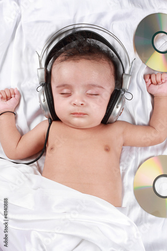 Photo: 2 Month old baby listening to music with headphones 2 Month old baby listening to music with headphones