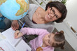Mother teaching daughter geography