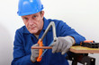 Artisan sawing copper pipe