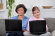 Mother and daughter each with their own laptop