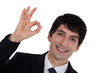 A businessman gesturing an ok sign.