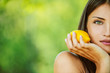 woman with bare shoulders holding lemon yellow