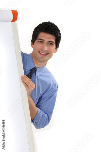 Photo: businessman standing behind a white board businessman standing behind a white board