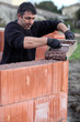 Mason carefully pouring cement