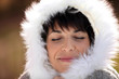 Woman keeping warm by wearing furry hood