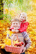 brother and sister in autumn garden