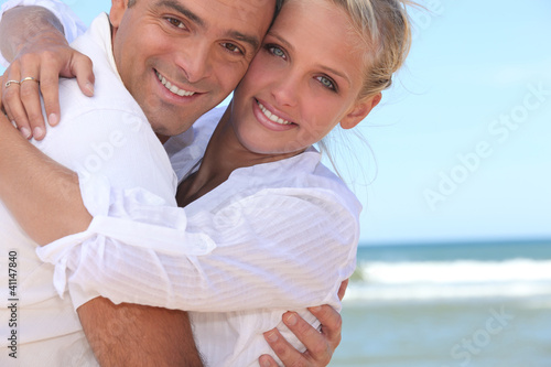 Photo: Couple embracing on the beach Couple embracing on the beach